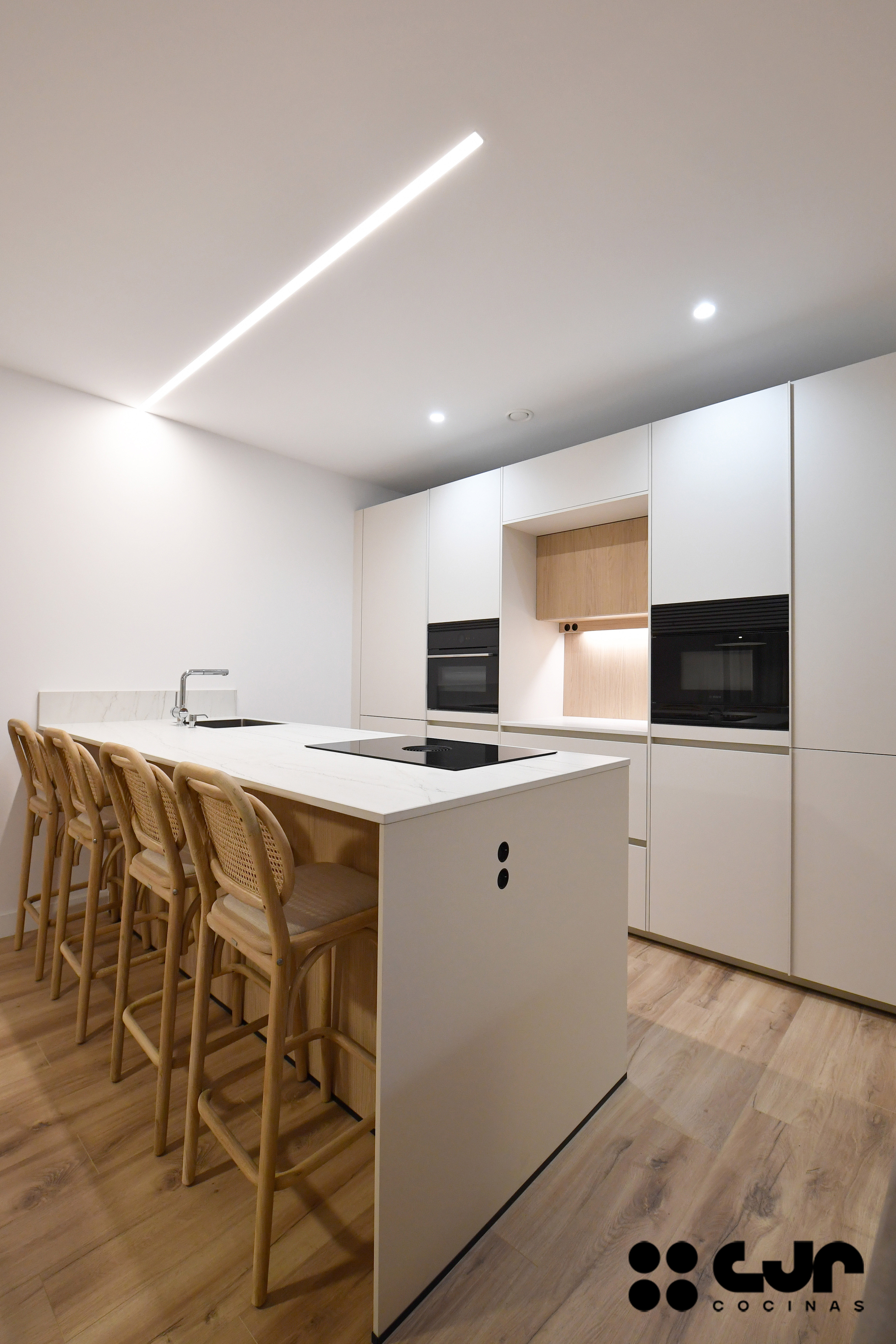 cocina blanca y madera con peninsula cocinas cjr