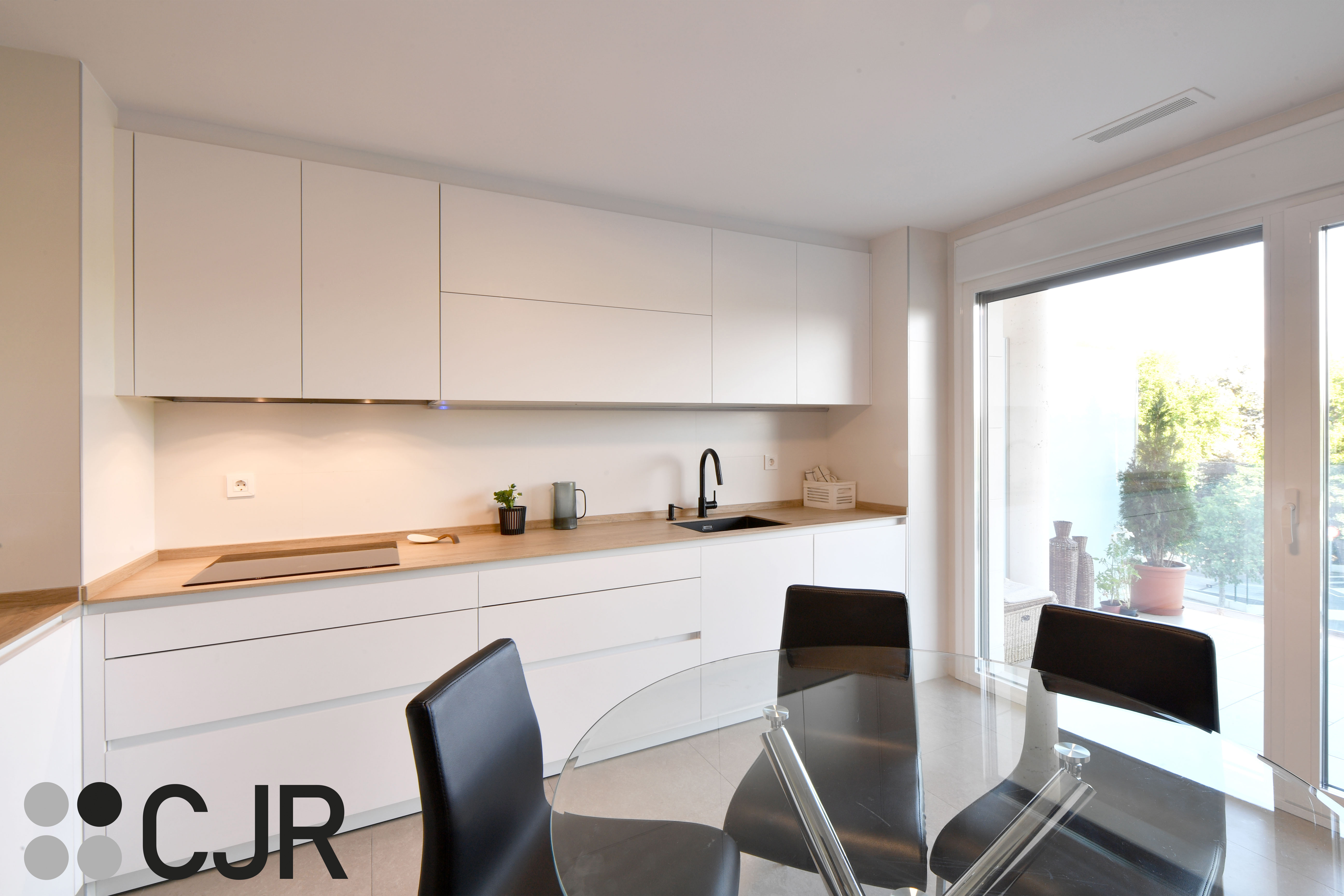 Cocina blanca y madera en dos frentes con mesa cocinas cjr