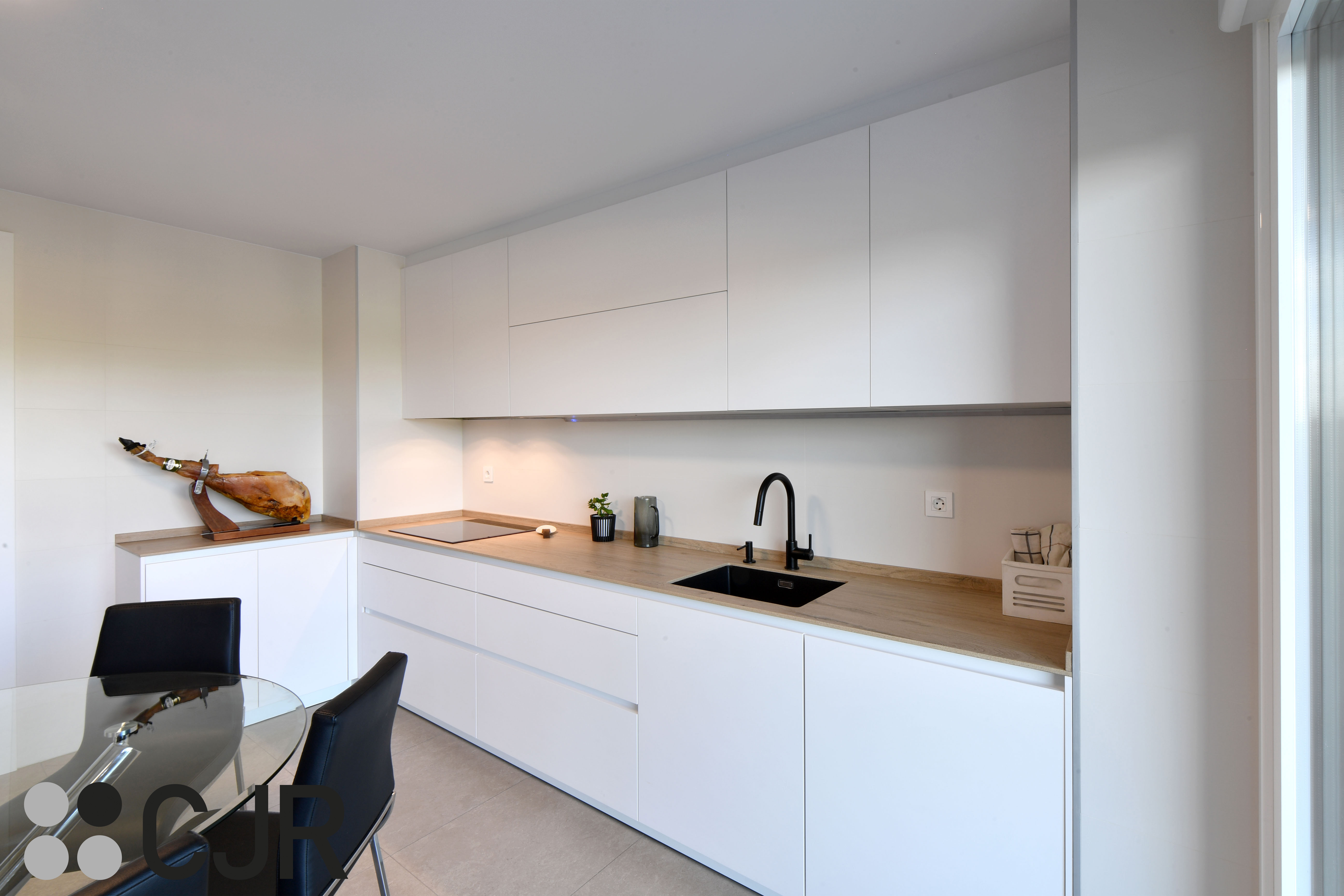 Cocina blanca y madera en dos frentes con mesa cocinas cjr